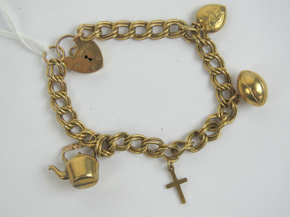 A 9ct gold charm bracelet with heart padlock clasp hallmarked 375, having four 9ct gold charms upon,