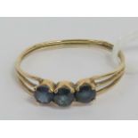 A 9ct gold and three stone sapphire ring, hallmarked 375, size M, 1g.