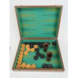 A well made oak case opening to reveal green baise backgammon board and turn ebonised and boxwood