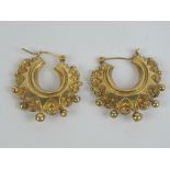 A pair of yellow metal hoop earrings, slightly a/f, 2.3g.
