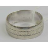 A white metal band having partial hallmark, interlocking circle pattern to front, size U, 5.2g.