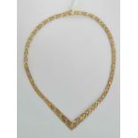 A silver articulated necklace having tri-colour gold plated panels, hallmarked 925, 45g.