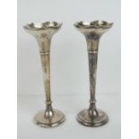 A pair of HM silver bud vases, one base weight deficient, hallmarked Chester 1917, each standing 17.