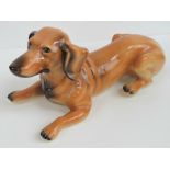 A large ceramic dachshund fireside figurine, a/f, 50cm in length.
