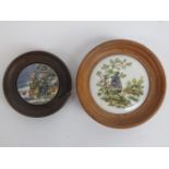Two Prattware style pot lids mounted in wooden frames, 7.5cm and 10.5cm dia respectively, a/f.