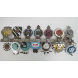 A quantity of car badges mounted on a badge bar and some loose including Northamptonshire Regiment,