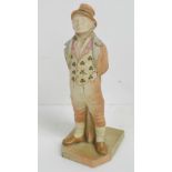 A Worcester figurine of an Irish gentleman with clover themed waistcoat, part gilded throughout,