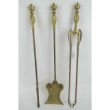 A large three piece fireside companion set comprising poker, tongs and shovel,