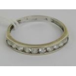 A white gold half eternity ring having ten channel set round cut white stones, partial mark ?8?k,