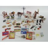 A quantity of dolls house items including toys, sewing items, mannequins, ironing boards,