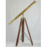 A brass telescope complete with end caps, marked Ross London, with tripod stand.