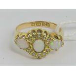 An Edwardian 18ct gold opal and diamond ring having central oval opal flanked by two transverse set