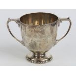 A heavy HM silver twin handled trophy cup engraved 'W. A.