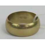 An 18ct gold band, 9mm wide, size U-V, stamped 750 18k, 8.6g.