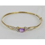 A 9ct gold bangle having central claw set oval cut amethyst approx 0.86ct (approx 7.8 x 5.8 x 3.