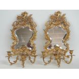 A pair of contemporary Continental style three sconce pier mirrors each having bevelled glass,