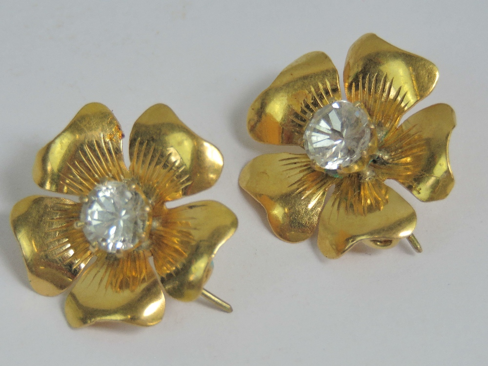 A pair of floral earrings each having five petals and central claw set moissanite, each approx 0.