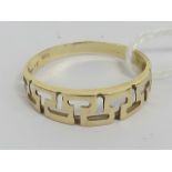 A 14ct gold ring having pierced Greek key pattern to front, stamped 585, size R, 1.7g.