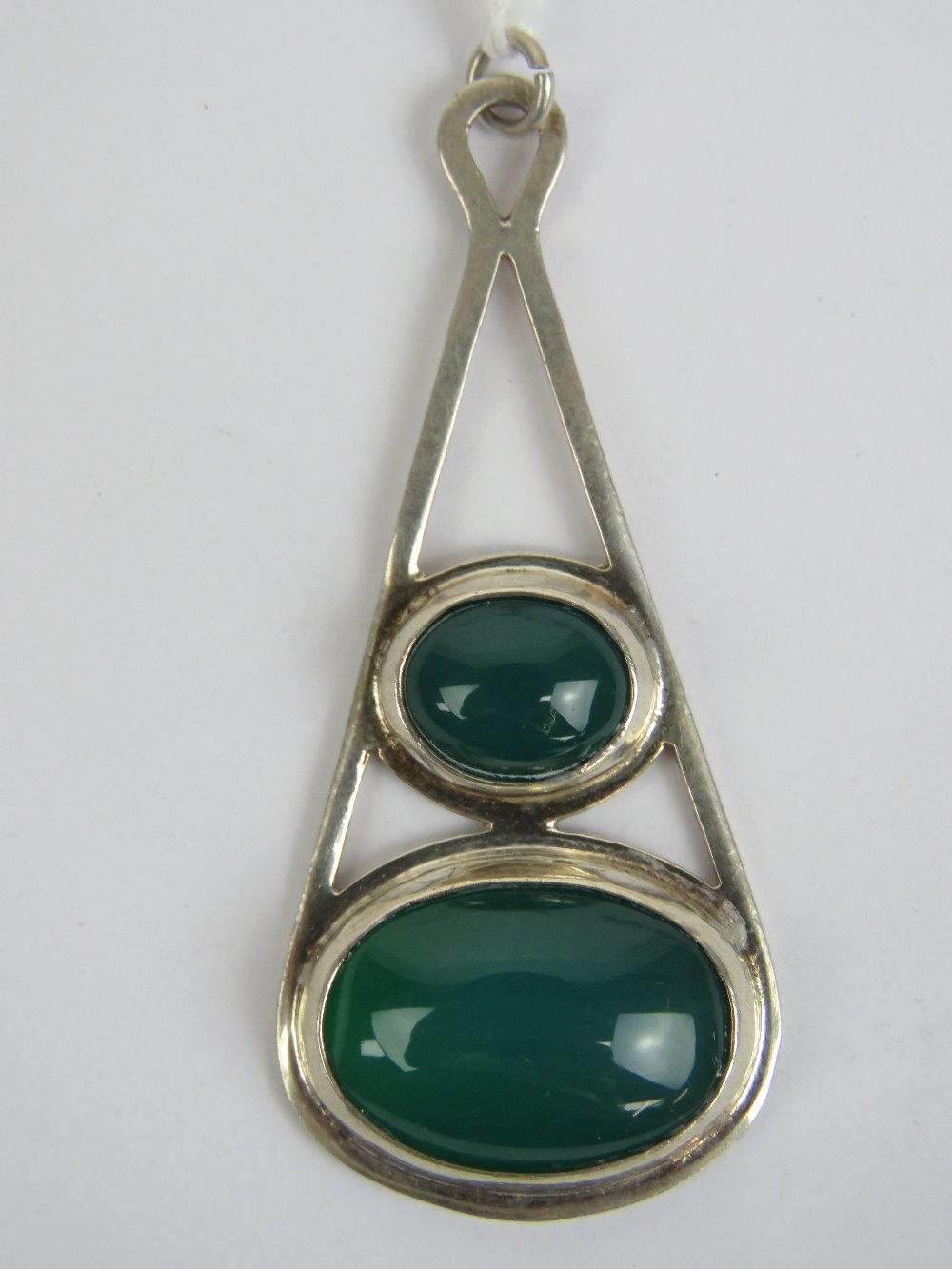 A large HM silver green onyx pendant having two graduated oval cabachons on an open frame,