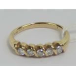 A 9ct gold and diamond ring, five round cut brilliant diamonds (approx 0.