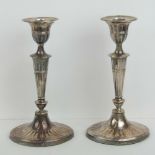 A good pair of HM silver single candlesticks having oval gadrooned bases,