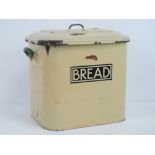 A vintage enamelled bread bin in yellow and green, with lid, measuring, 30 x 22 x 30cm.