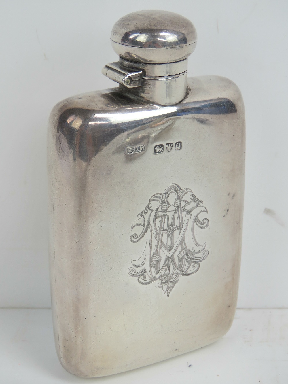 A HM silver lidded flask having screw top and engraved monogram upon, hallmarked Chester.