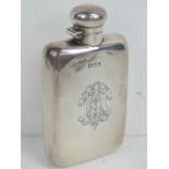 A HM silver lidded flask having screw top and engraved monogram upon, hallmarked Chester.