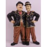 A contemporary resin figurine of Laurel and Hardy standing 50cm high.