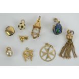 A quantity of gold and yellow metal charms or pendants including; 18ct gold horse and horseshoe (2.