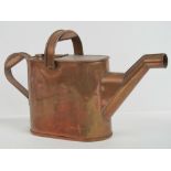 An Edwardian copper hot water can with double handle standing 24cm high.