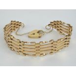 A 9ct gold five bar gate link bracelet with heart padlock clasp, hallmarked 375, 10.6g.