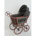 A dolls pram complete with cover, measuring 50cm in length.