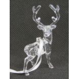 A Swarovski crystal Christmas tree ornament in the form of a stag, complete with box.