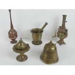 A heavy brass mortar and pestle together with an Oriental brass bell and three other copper and