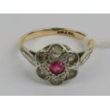 A vintage 9ct gold and silver daisy cluster ring having central round cut ruby, size M, 2.4g.