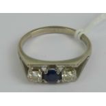 An 18ct white gold diamond and sapphire ring, central round cut sapphire approx 0.