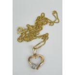 A 9ct gold heart shaped pendant having diamond cluster upon, stamped 375, on fine 9ct gold chain,