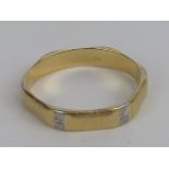 An 18ct white and yellow gold hexagonal band, hallmarked 750, size T, 4g.