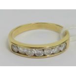 An 18ct gold and diamond ring, seven round cut brilliant diamonds (approx 0.