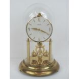 A Bentima brass four hundred day torsion clock with class dome c1960s, 32cm high.