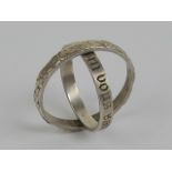 A delightful silver 'hidden message' ring, the outer ring having floral design,