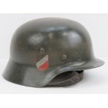 A reproduction WWII German Wehrmacht helmet with two decals, liner and chinstrap.