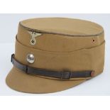 An original brown canvas covered peaked field cap bearing leather strap to peak with swastika and