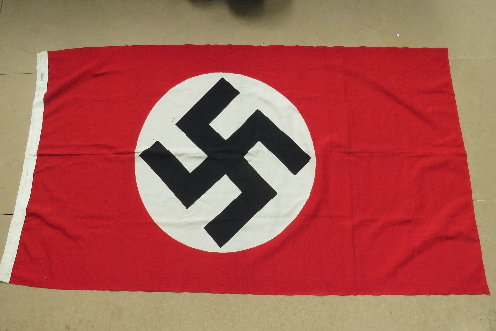 An WWII German flag measuring 100 x 170cm, having makers label upon.