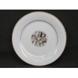 A white ground and part gilded porcelain plate believed to be an original dinner plate from Hermann