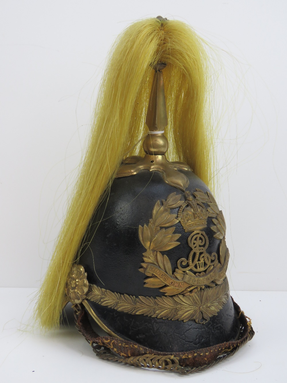 An early 20th century Edward VII Kings Own Norfolk Imperial Yeomanry leather helmet having gilt