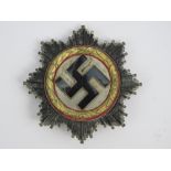 A reproduction WWII German Cross in 'gold' badge, stamped 1 to pin.