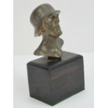 A contemporary gilt metal bust of a WWII German SS officer having SS decal on helmet,