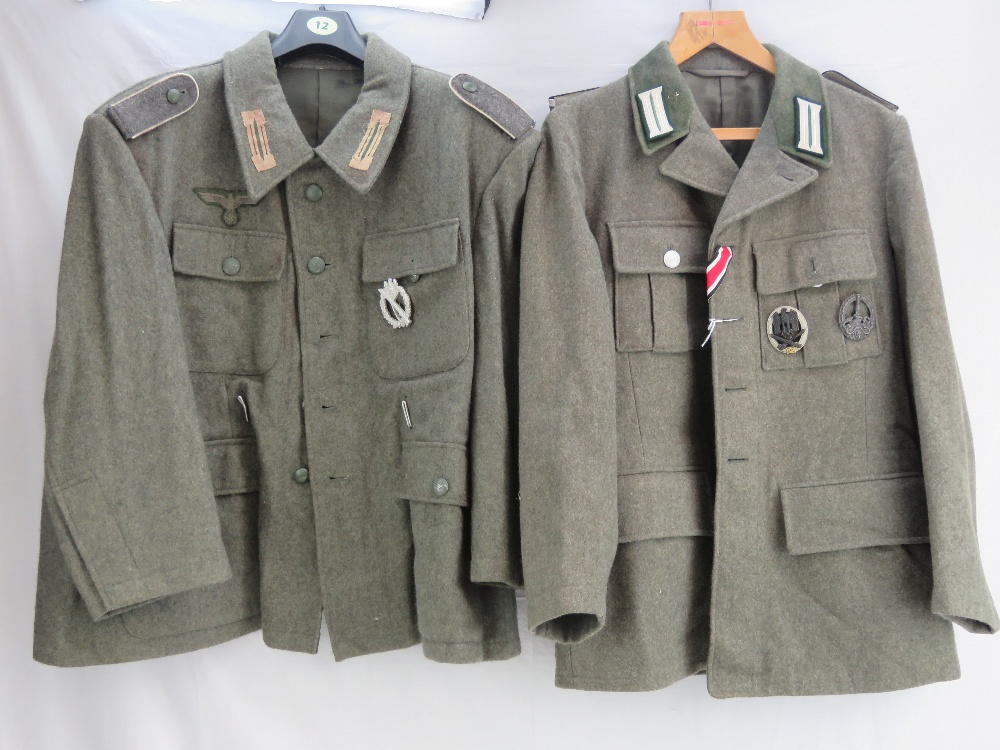 A reproduction WWII German tunic in the Wehrmacht style with 25 Assault badge and Anti Partisan